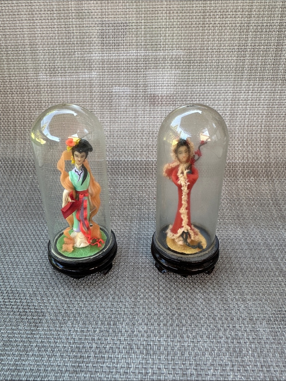 Miniature dolls under glass